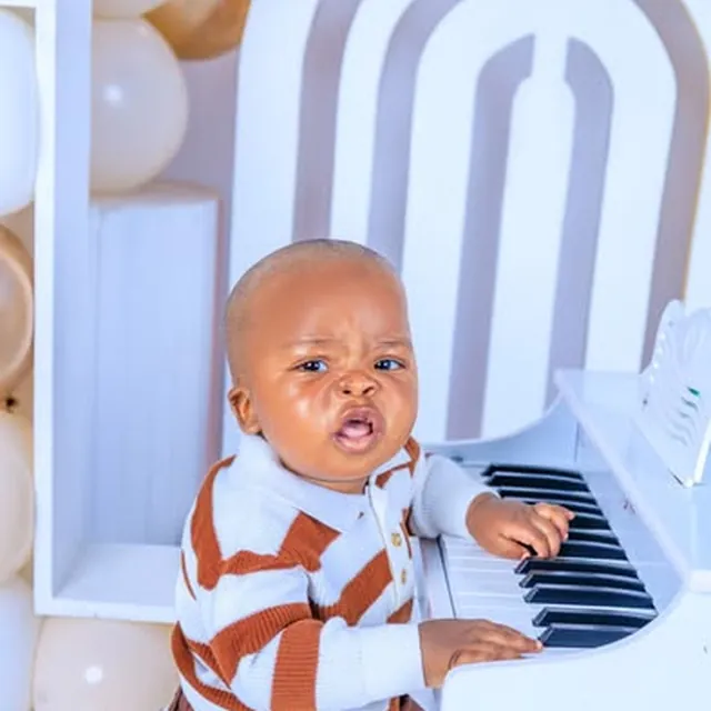 Baby's first birthday session at a toy piano, balloon backdrop