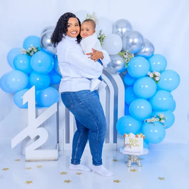 Mother and baby half-birthday milestone session, blue balloon arch