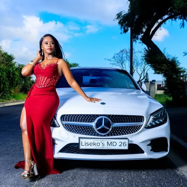 Matric dance photo shoot, red sequin gown beside a white Mercedes