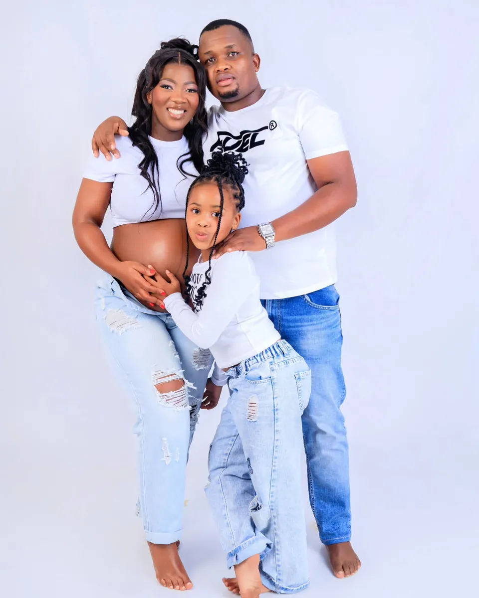 Family portrait session, three family members in matching white and denim