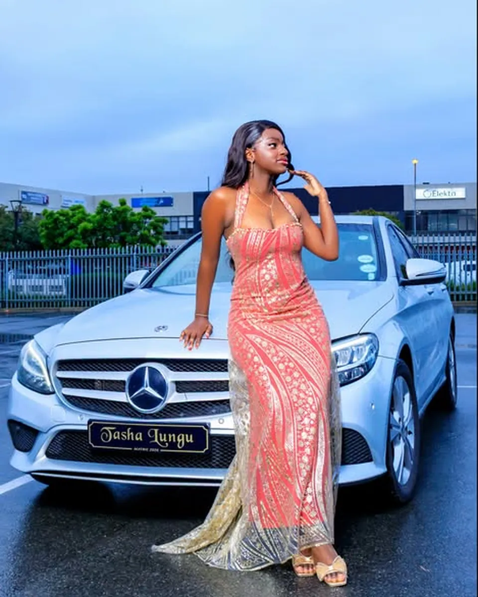 Matric dance photo shoot, client in a coral and gold gown beside her car